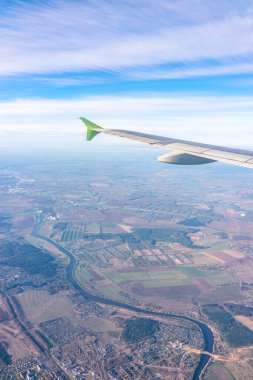 Güzel mavi bir güneş doğarken uçak penceresinden ve açık havada uçağın kanadını seyret. Dünya ve gökyüzü bir uçağın penceresinden görüldüğü gibi.
