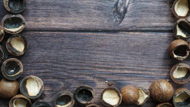 Tahta kahverengi arka planda Macadamia kabukları