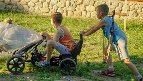 children play and ride a go-kart bike