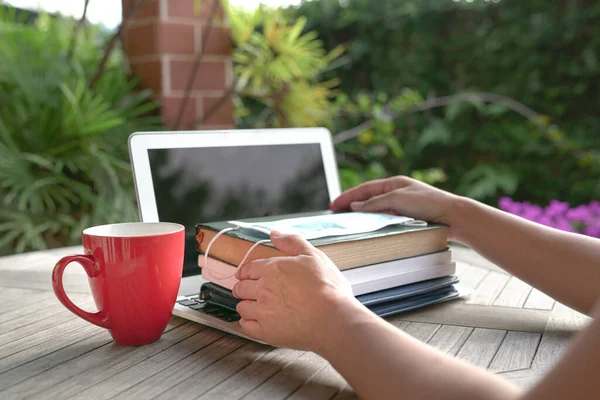 Woman Hands On Stacked Books With Face Mask On Top Of Open Laptop With Red Cup Study At Home During Pandemic Concept Stock Images Page Everypixel
