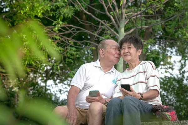 Senior Asian Man Kiss Cheek His Wife Outdoors Setting Loving — Stock Photo, Image