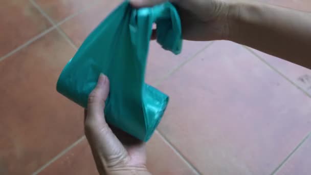 Vrouw Scheurt Nieuwe Blauwe Plastic Zak Uit Een Rol Concept — Stockvideo