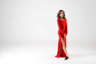 Dancing lady in a red dress. Contemporary modern dance on a white background isolated. Fitness, stretching model