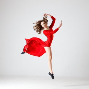 Dancing lady in a red dress. Contemporary modern dance on a white background isolated. Fitness, stretching model
