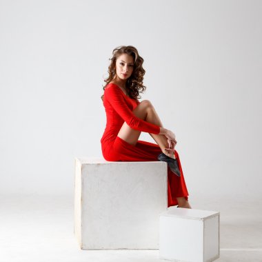 Dancing lady in a red dress. Contemporary modern dance on a white background isolated. Fitness, stretching model