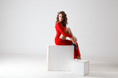 Dancing lady in a red dress. Contemporary modern dance on a white background isolated. Fitness, stretching model