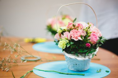 Çiçekçi işyeri: çiçek ve aksesuarları bir arka plan üzerinde bir sepet içinde güzel buket. yumuşak odak