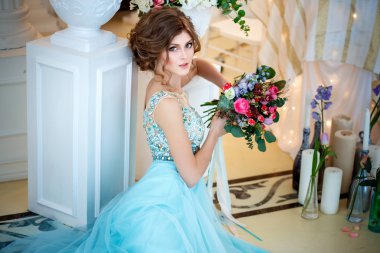 Bir lüks mavi güzel genç bayan elbise bir buket çiçek ile zarif iç