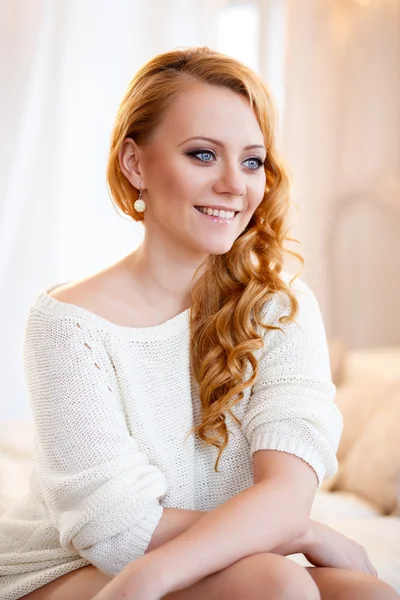 Młoda piękna kobieta w ciepły sweter w światło sypialni rano. Bliska portret, niebieskie oczy i naturalny makijaż — Zdjęcie stockowe