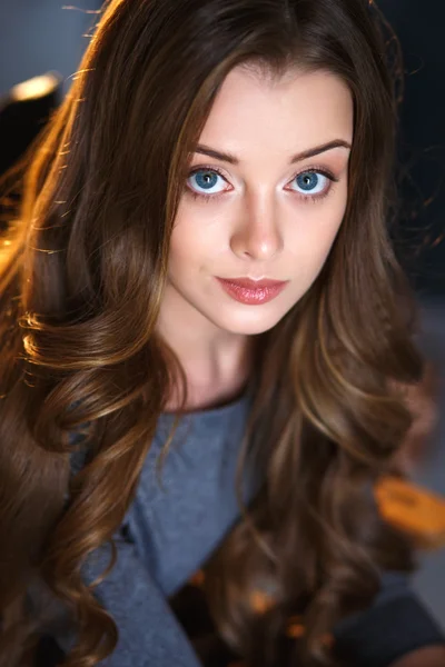 Emotional portrait of a young sensual woman with long curly hair and natural makeup — Zdjęcie stockowe