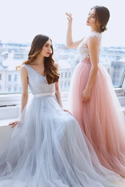 Duas noivas em um rosa claro terno e vestidos de casamento azuis em uma manhã. Retrato de beleza de moda — Fotografia de Stock