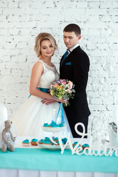 Noiva elegante e noivo juntos em um dia de casamento em um espaço loft moderno. Candy bar em um restaurante — Fotografia de Stock