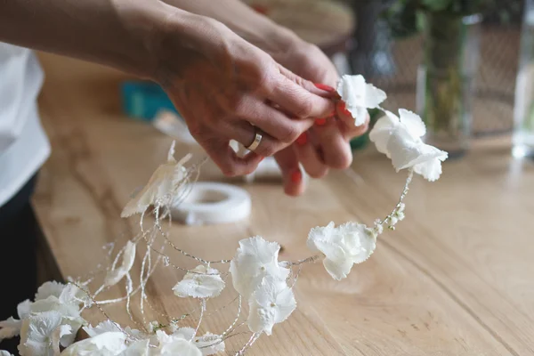 Флорист на роботі: жінка робить квіткову композицію з різних квітів — стокове фото