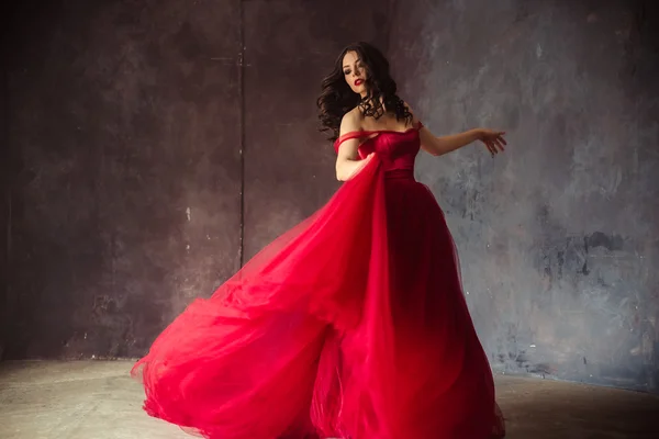 Portrait of sensual woman in a long gorgeous red dress — Stock Photo, Image