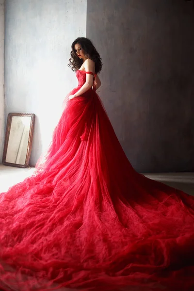 Portrait of sensual woman in a long gorgeous red dress — Stock Photo, Image