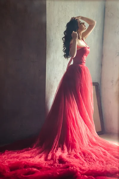 Portrait of sensual woman in a long gorgeous red dress — Stock Photo, Image