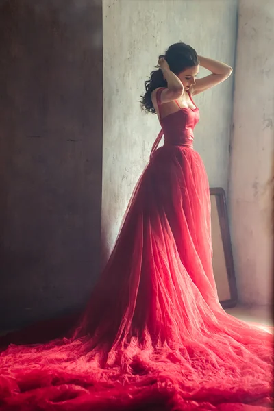 Portrait of sensual woman in a long gorgeous red dress — Stock Photo, Image