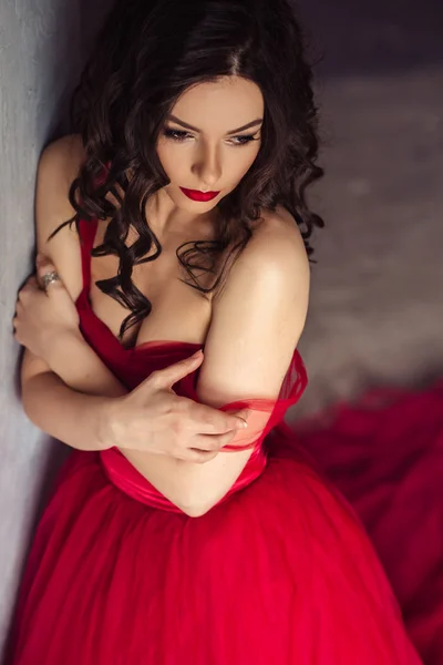 Portrait of sensual woman in a long gorgeous red dress — Stock Photo, Image