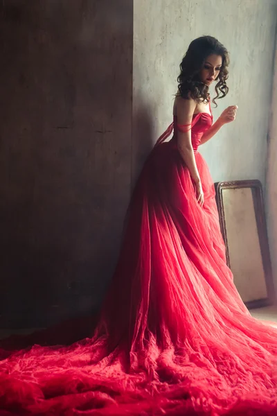 Portrait of sensual woman in a long gorgeous red dress — Stock Photo, Image