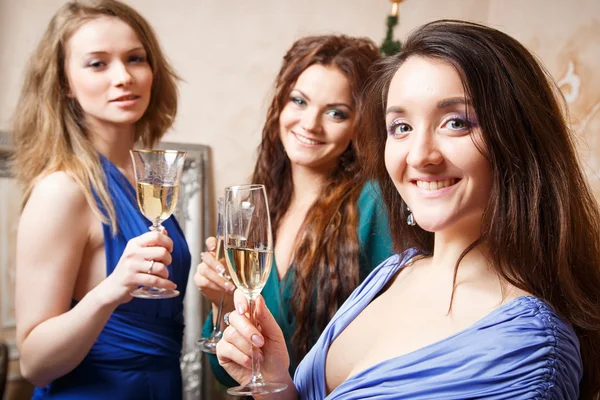 Group of beautiful young women with glasses of champagne celebrating New Year — Stock Photo, Image