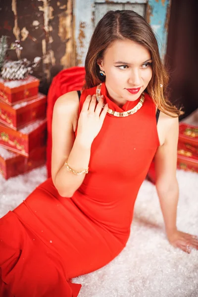 Portrait of beautiful sweet young woman in gorgeous evening dress over Christmas background. — Stock Photo, Image
