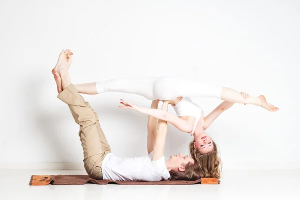 Young couple in yoga pose — Stock Photo, Image