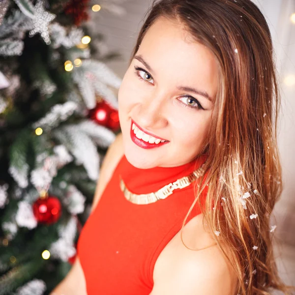 Portrait of beautiful sweet young woman in gorgeous evening dress over Christmas background. — Stock Photo, Image