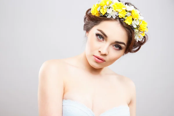 Gyönyörű fiatal nő, a tökéletes smink és frizura haj virágok közelről portréja — Stock Fotó