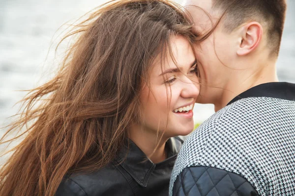 Sweet young couple walking together in a park in a summer day — Stock Photo, Image