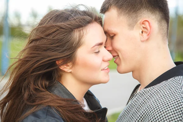 Dulce pareja joven caminando juntos en un parque en un día de verano — Foto de Stock