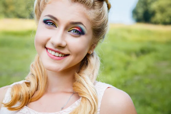 Close-up portrait of sweet young pretty blonde girl with colored make-up. Summer, outside — Stock Photo, Image