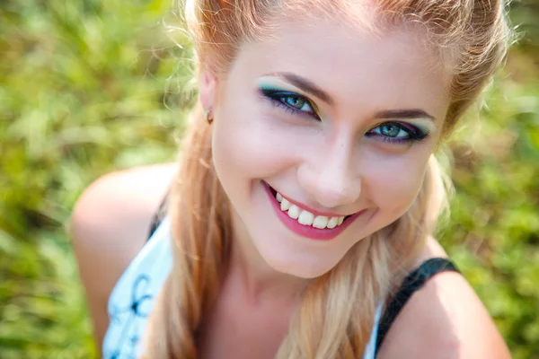 Close-up portrait of sweet young pretty blonde girl with colored make-up. Summer, outside — Stock Photo, Image