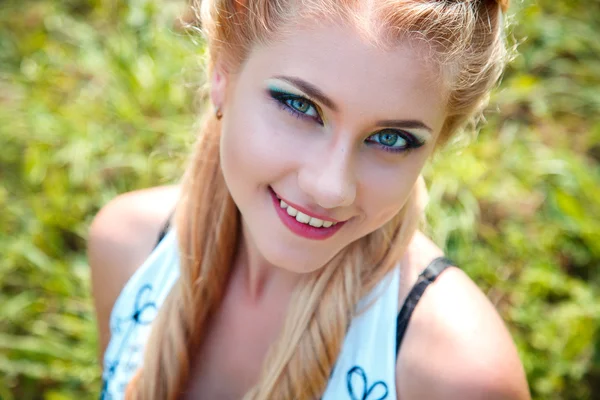 Close-up portrait of sweet young pretty blonde girl with colored make-up. Summer, outside — Stock Photo, Image
