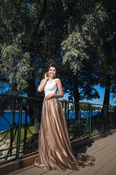 Portrét krásné elegantní nevěsta v nádherné béžové šaty procházky v parku — Stock fotografie