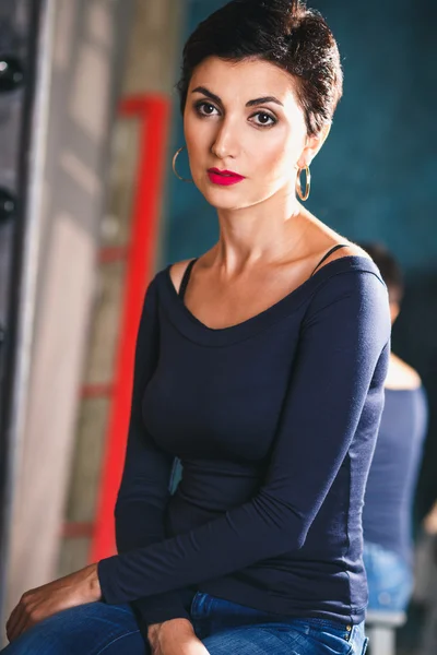 Close-up portrait of gorgeous woman with short black hair and long earrings — Zdjęcie stockowe