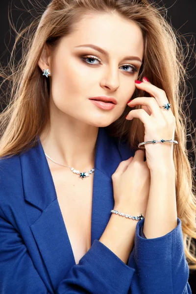 Close-up portrait of beautiful young woman in blue jacket with luxury jewelry and perfect make up. Fashion beauty portrait — Stok fotoğraf