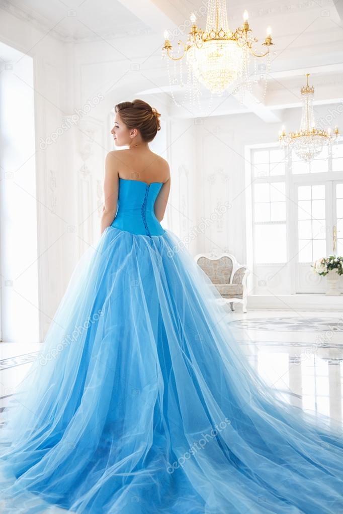 Beautiful bride in gorgeous blue dress Cinderella style in a morning