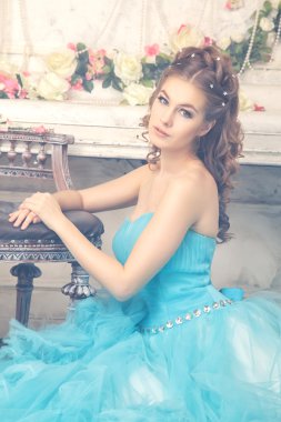 Muhteşem mavi uzun elbiseli güzel genç kadın mükemmel makyajlı ve saç stili olan Cinderella gibi.