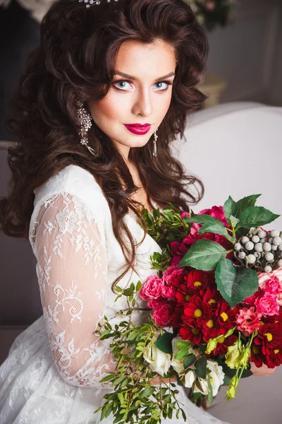 Primer plano retrato de hermosa novia hermosa en vestido blanco con estilo de pelo increíble y maquillaje, la celebración de ramo — Foto de Stock
