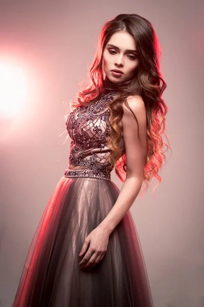 Fashion beauty portrait of gorgeous young woman with long curly hair in luxury evening dress — Stock Photo, Image