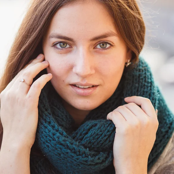 Portrait of young lady wearing green scarf posing on a balcony — 图库照片