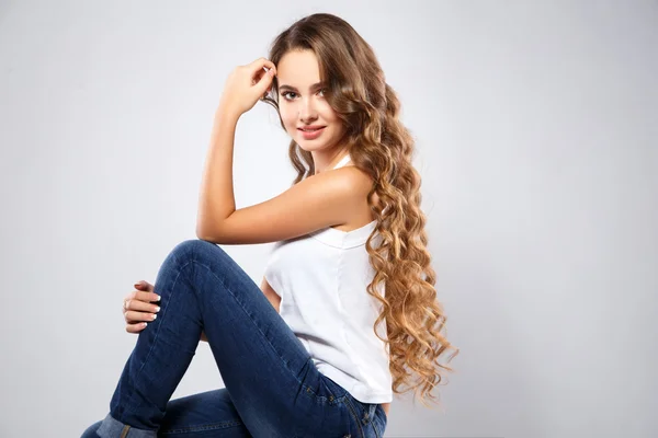 Close-up portrait of beautiful young woman with gorgeous hair and natural makeup wearing casual clothes. Fashion beauty photo, casual jeans style — Stockfoto