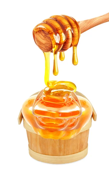 Honey dripping in a bucket — Stock Photo, Image