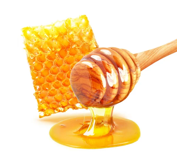 Druppelen Van Honing Honingraat Geïsoleerd Stockfoto