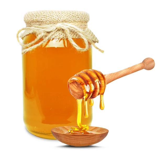 蜂蜜在罐子里 滴入碗中 与白色隔离 免版税图库照片