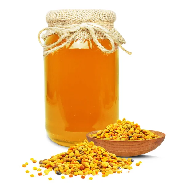 Honig Glas Und Pollen Einer Schüssel Isoliert Auf Weiß lizenzfreie Stockfotos