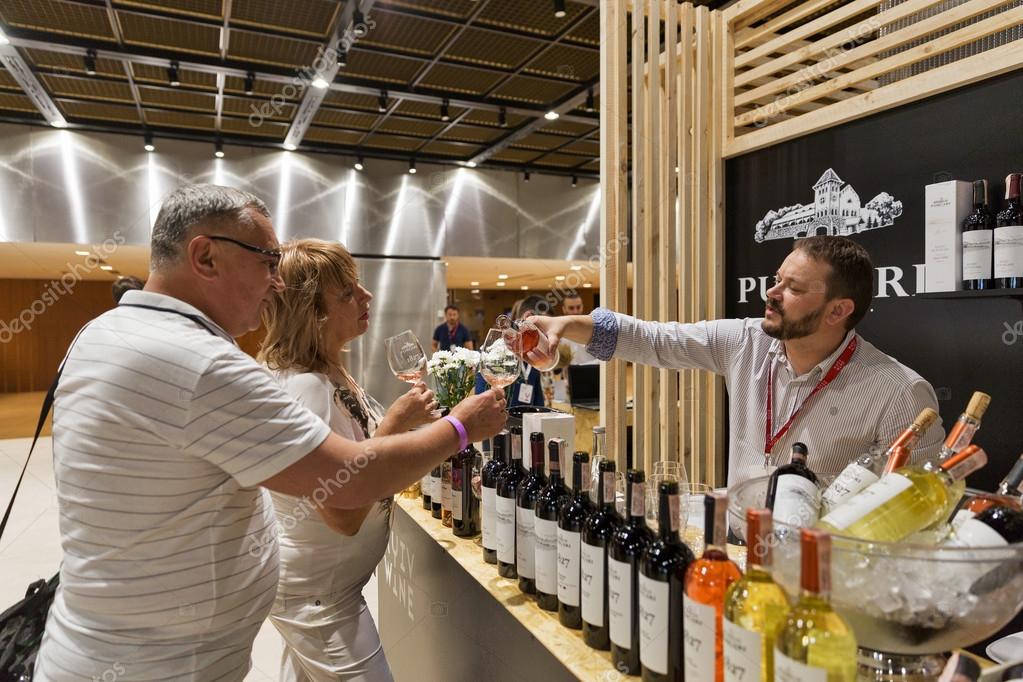 KIEV, UKRAINE - June 04, 2016: Unrecognized people visit booth and taste Chateau Purcari wine from Moldova at Kyiv Wine Festival organized by Good Wine company in Parkovy Exhibition Center.