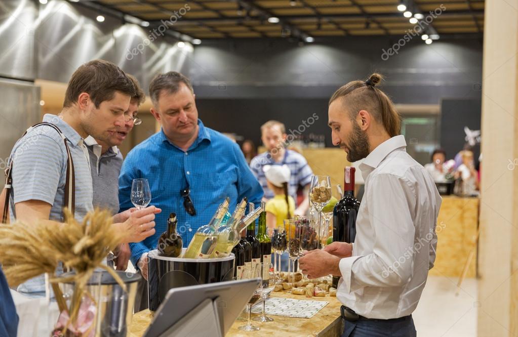 KIEV, UKRAINE - JUNE 04, 2016: Unrecognized people visit Kolonist Ukrainian winery booth at Kyiv Wine Festival organized by Good Wine company in Parkovy Exhibition Center.