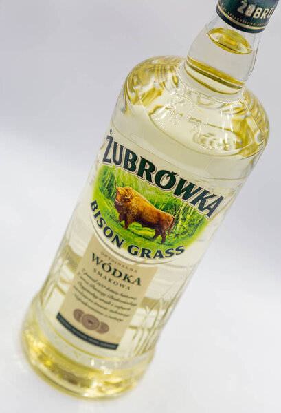 KYIV, UKRAINE - OCTOBER 23, 2020: Zubrowka Bison Grass vodka bottle closeup against white background. It is a flavored Polish vodka liqueur, which contains a bison grass blade in every bottle.
