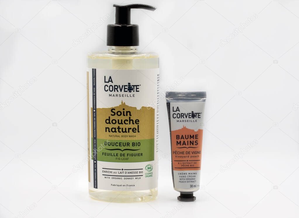 KYIV, UKRAINE - MARCH 08, 2021: Studio shot of French La Corvette Marseille natural body wash shower treatment and hand balm creme with organic peach extract bottles closeup against white background.